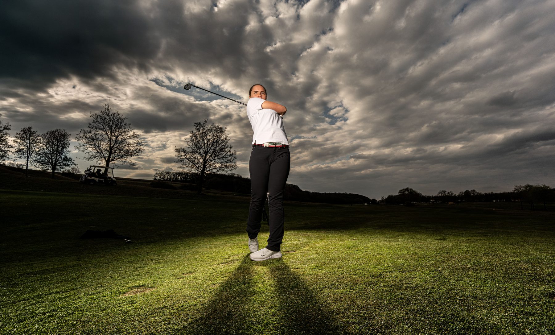 Sports portrait on a golf course, dramatic cloudy sky