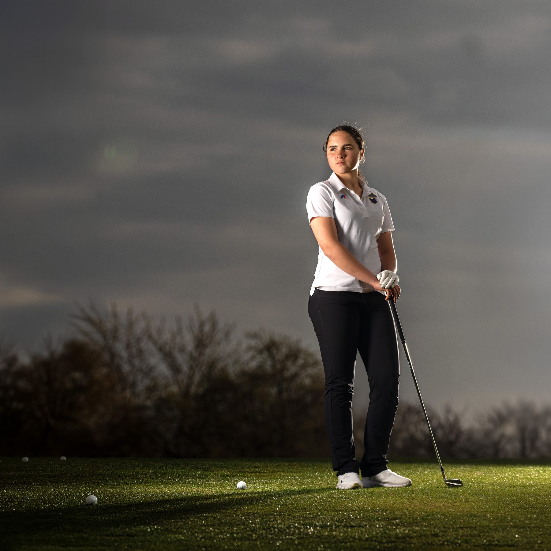 Standing portrait on a golf course, dramatic light