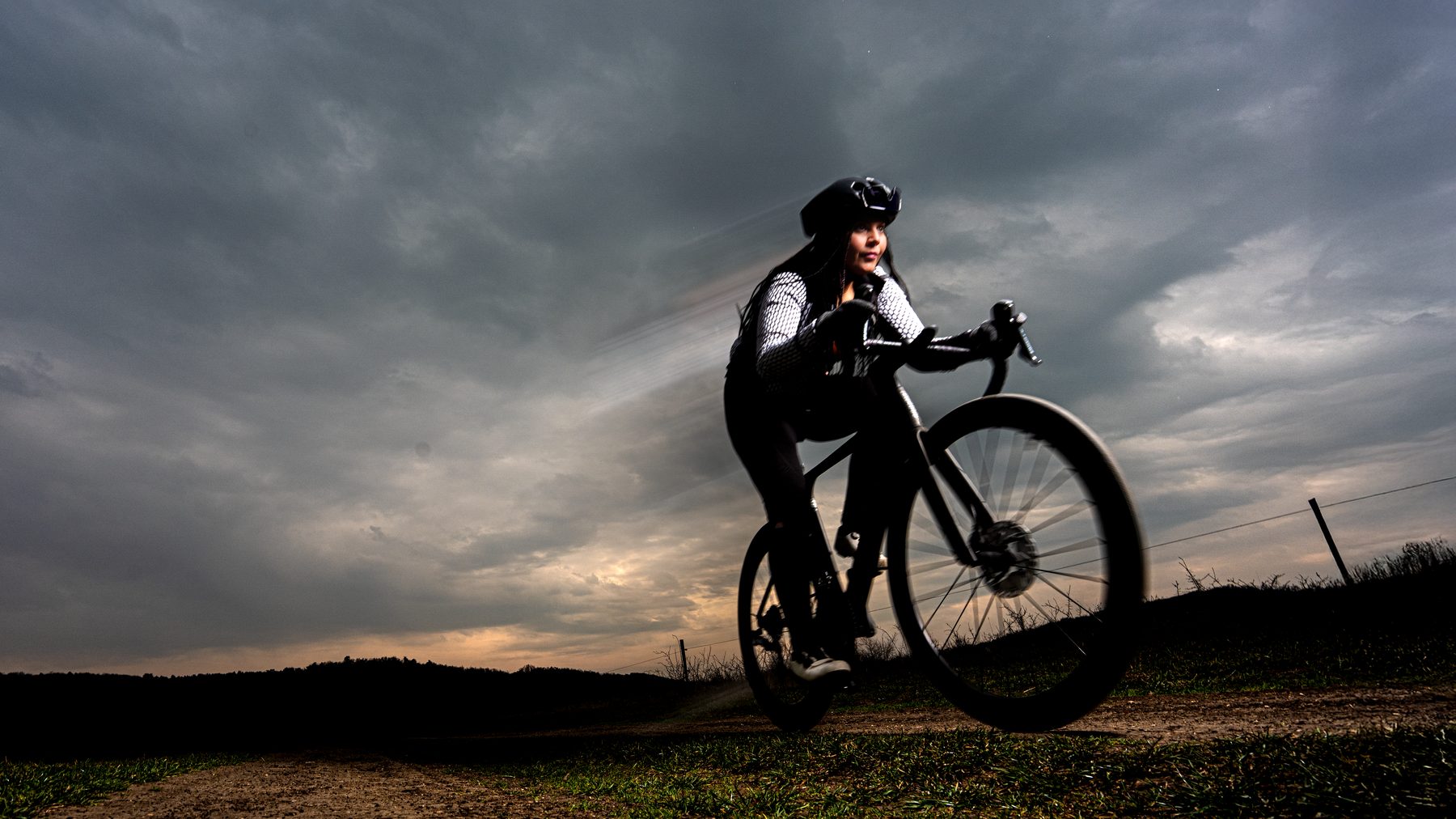 Cyclist in action, stormy sky