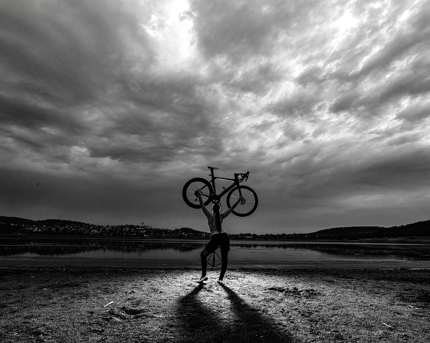 Cyclist silhouette, by a lake