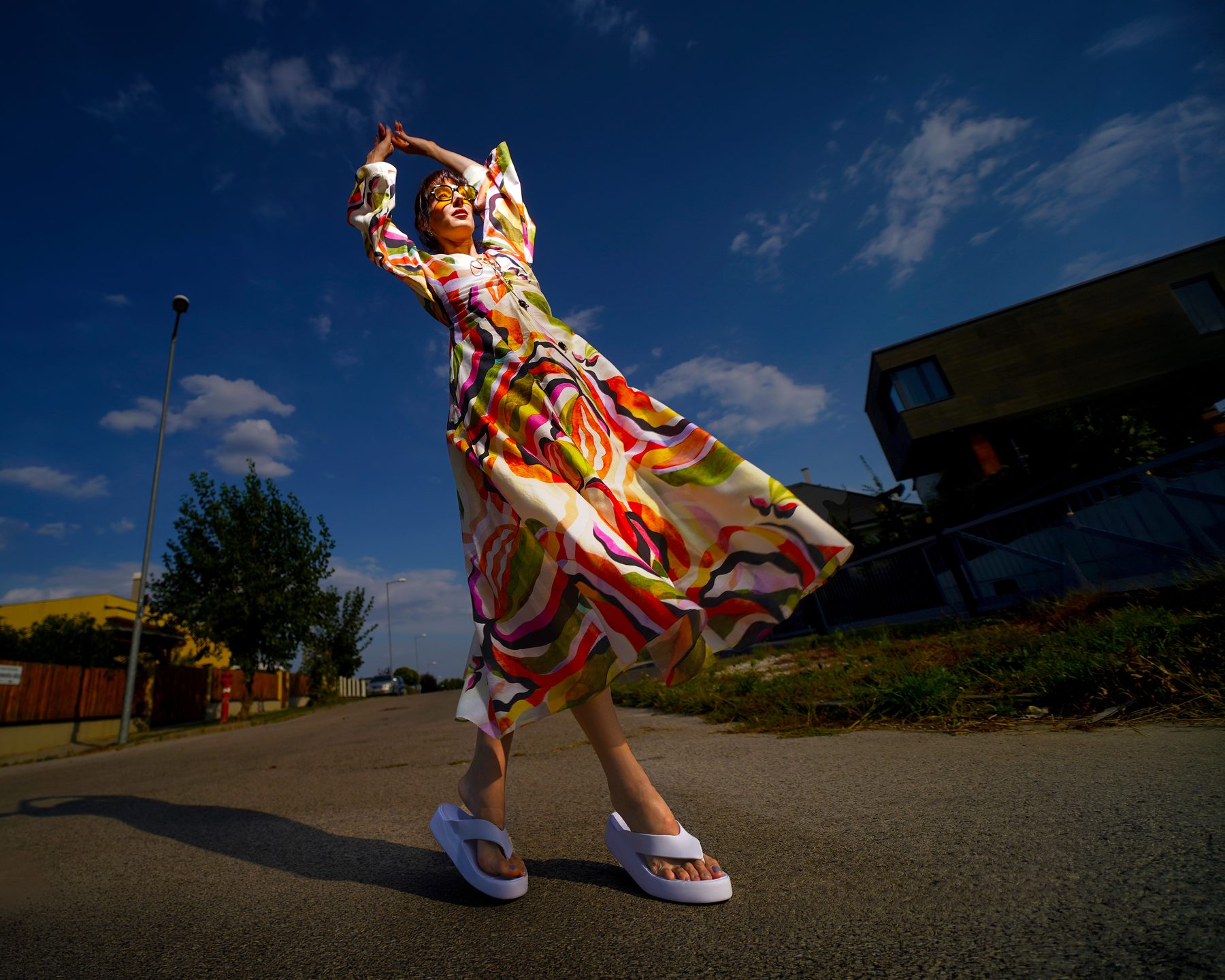 Street portrait, in a colorful dress, in motion