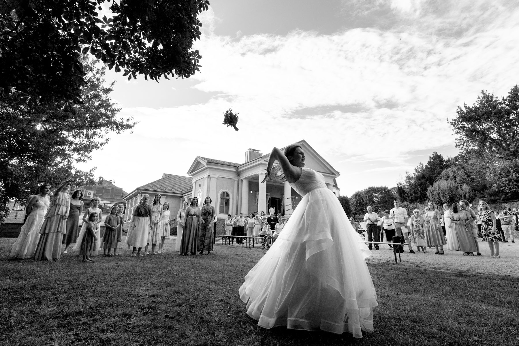 Bouquet toss in black and white